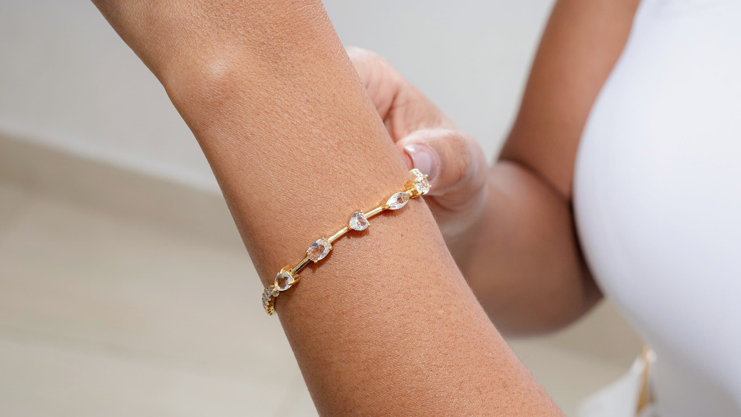 A wrist wearing a delicate crystal bracelet